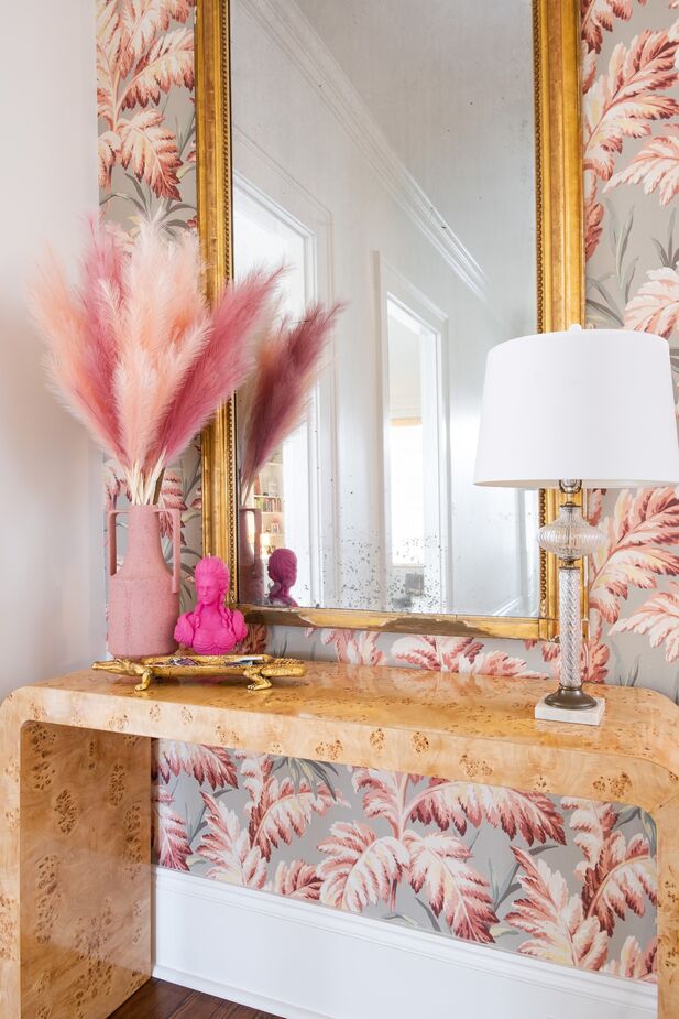 Hattie used wallpaper to liven up small spaces throughout the home, including this hallway. Find a similar mirror here.
