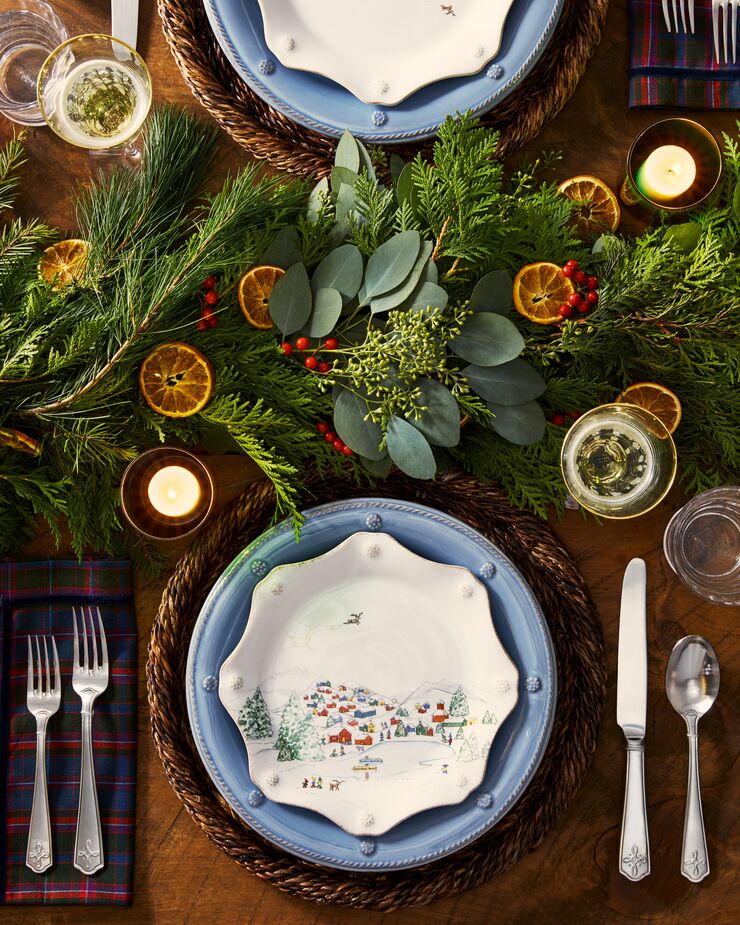 Replace your table runner with a festive garland. Not only does it bring a touch of the outdoors in, but it’s also one less item you have to wash. Find the charger/place mat here, the blue dinner plate here, and the dessert/salad plate here. 
