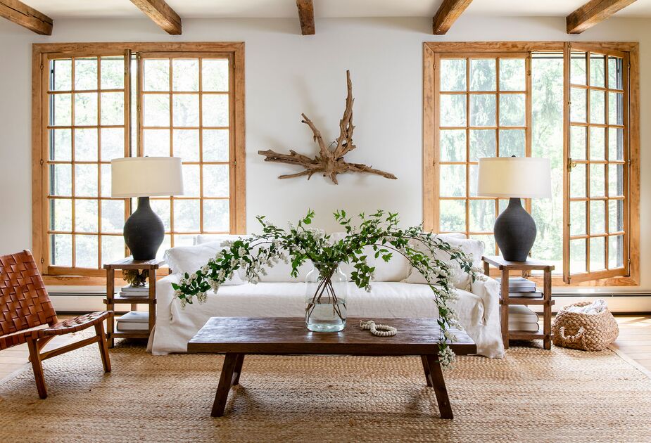 A cornucopia of woven materials, from the breezy linen slipcover of the Courtier Sofa to the chunky natural-fiber rug, give this room layers of texture and natural elegance. Find the side tables here.
