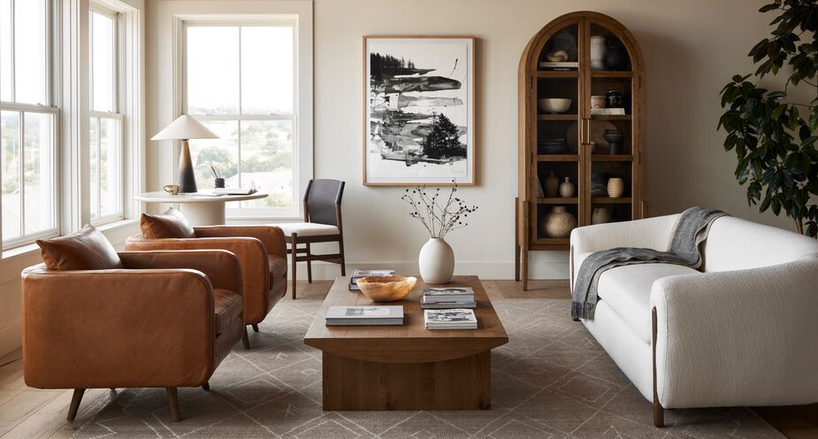 Including one major piece in a light hue, such as the Renee Performance Sofa, keeps a room from falling prey to the ’70s brown-on-brown-on-brown look. This sofa’s visible wood legs keep the look cohesive. Also shown: the Talia Arched Cabinet in Drifted Oak.  
