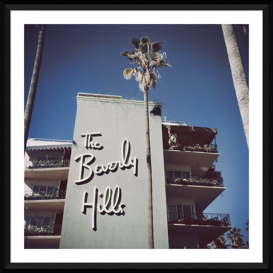 In addition to creating the Beverly Hills Hotel’s Crescent Wing, Crystal Ballroom, and poolside cabanas, Paul R. Williams designed the logo and its type font still used today. Find this framed Slim Aarons print here. 
