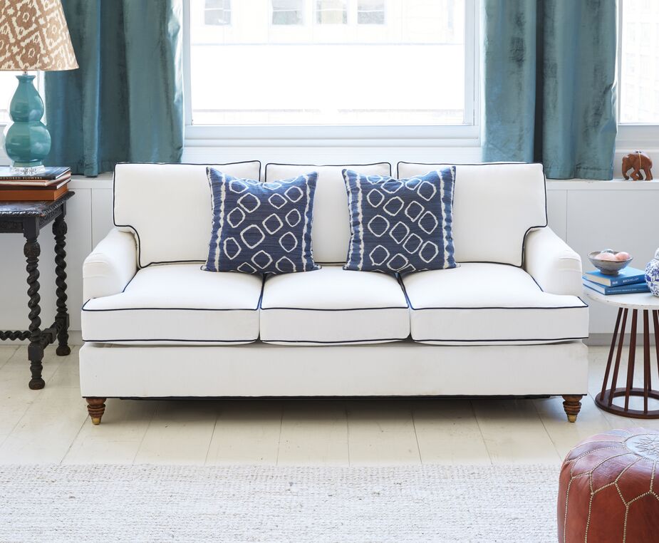 Navy piping provides a sharp contrast to the Kate Sofa’s white Crypton upholstery and ensures that the piece stands out.
