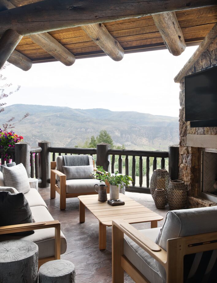 As well as bringing the outdoors in, this home brings the comforts of the indoors outside. This balcony, for instance, includes a TV and a fireplace.
