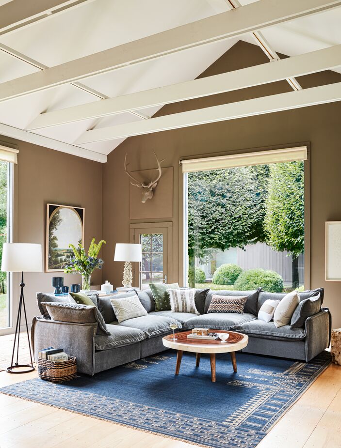 A sectional such as the Parker Performance Velvet L-Sectional can help create “zones” within a large open space. Also shown: the Freddie Coffee Table and the Duar Kaba Southwest Rug. Photo by Joe Schmelzer.
