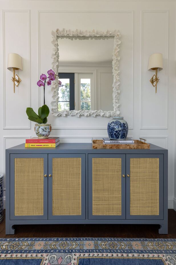 Moldings added to the entryway frame the Etoile Sconces and the dramatic mirror. 
