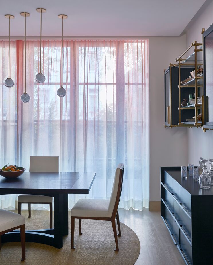 The dining area’s pink ombré window sheers reference both the living room’s wall color and a Tuscan sunset.
