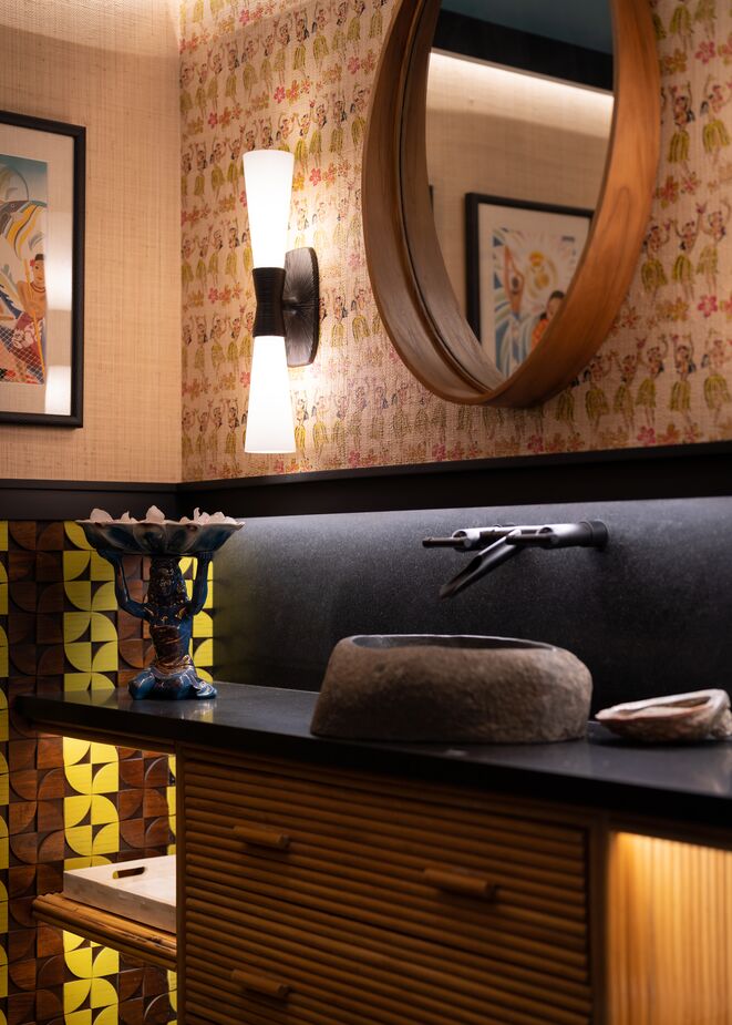 “Midcentury Polynesian” was the theme of the powder room designed by Linda Allen of Linda Allen Designs. A small space like this minimizes any risks in going big on a design.  
