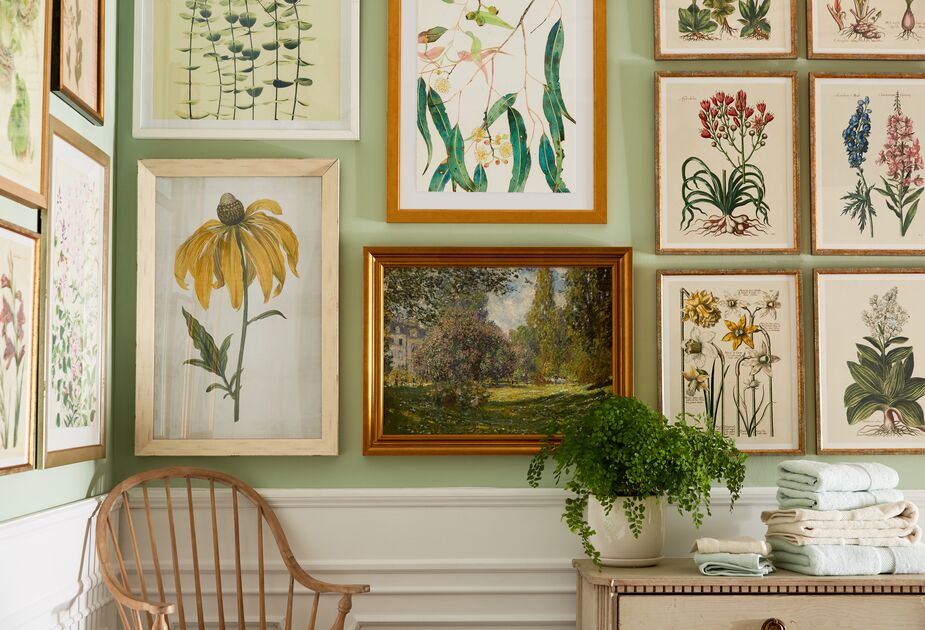 The dark greens and burnished golden frame of the landscape painting keep this botanical-themed gallery wall from feeling too summery.
