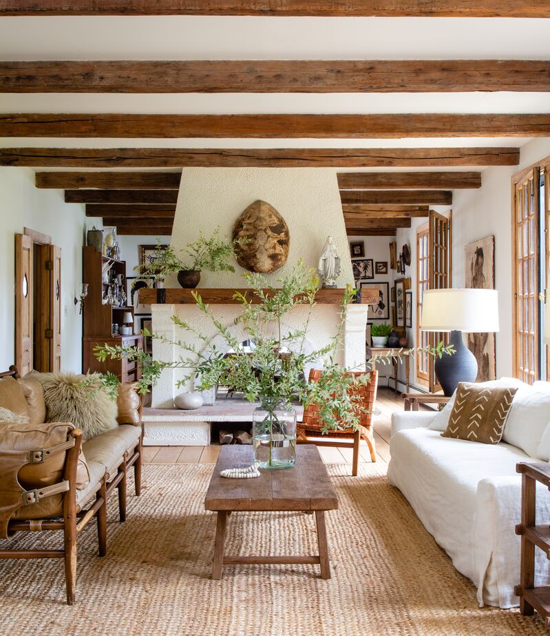 Without the aged ceiling beams, this room would feel cold rather than warmly rustic. Find the sofa here, the coffee table here, and a similar rug here. Photo by Helen Norman.
