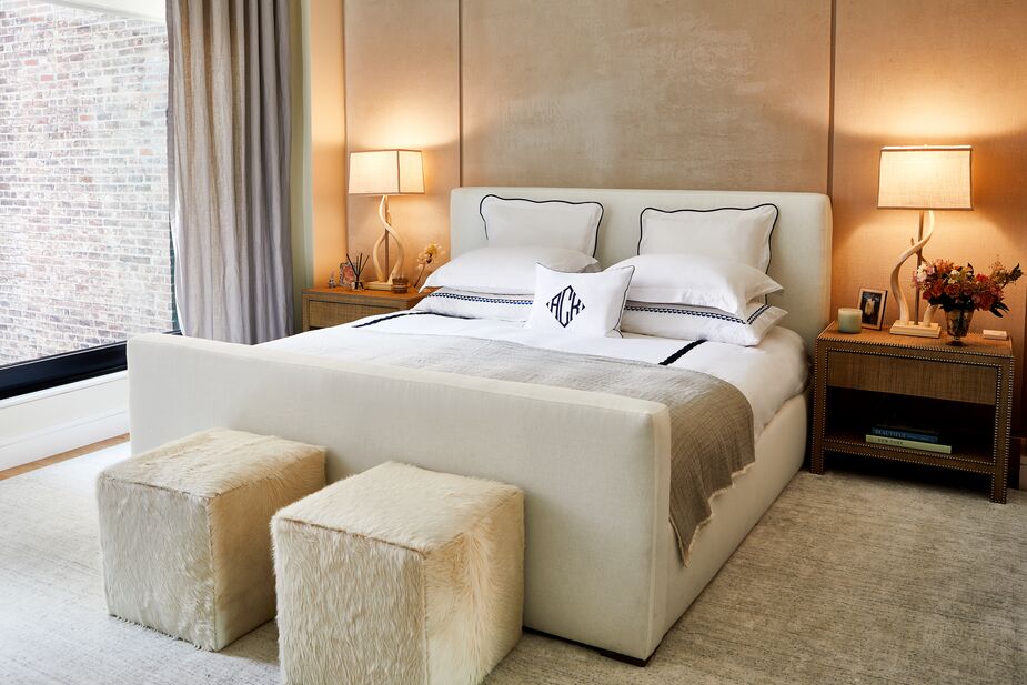 Pristine white bedding, the well-cushioned upholstered Nemus Bed, restful symmetry, and a quiet palette are among the elements One Kings Lane Interior Design incorporated to give this bedroom hotel-quality chic. Find similar table lamps here. Photo by Tony Vu. 
