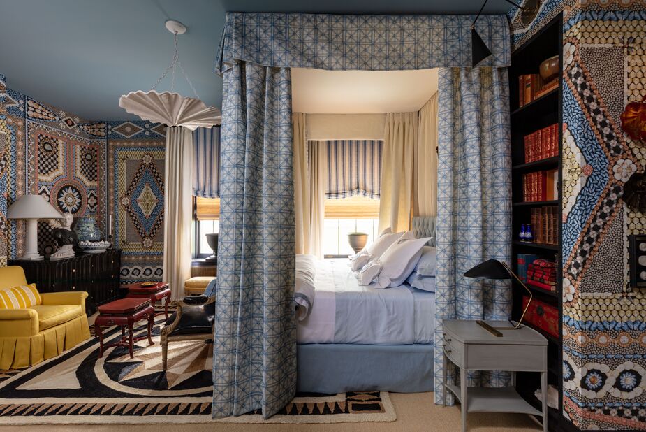 “For this sweet niche of a bedroom, I chose a contemporary and ladylike nod to the women of centuries past: those who traveled, wrote, and collected ephemera and natural curiosities from around the world,” says Mary McDonald. And should the wealth of patterns become a bit too stimulating, all one has to do is close the bed curtains. 
