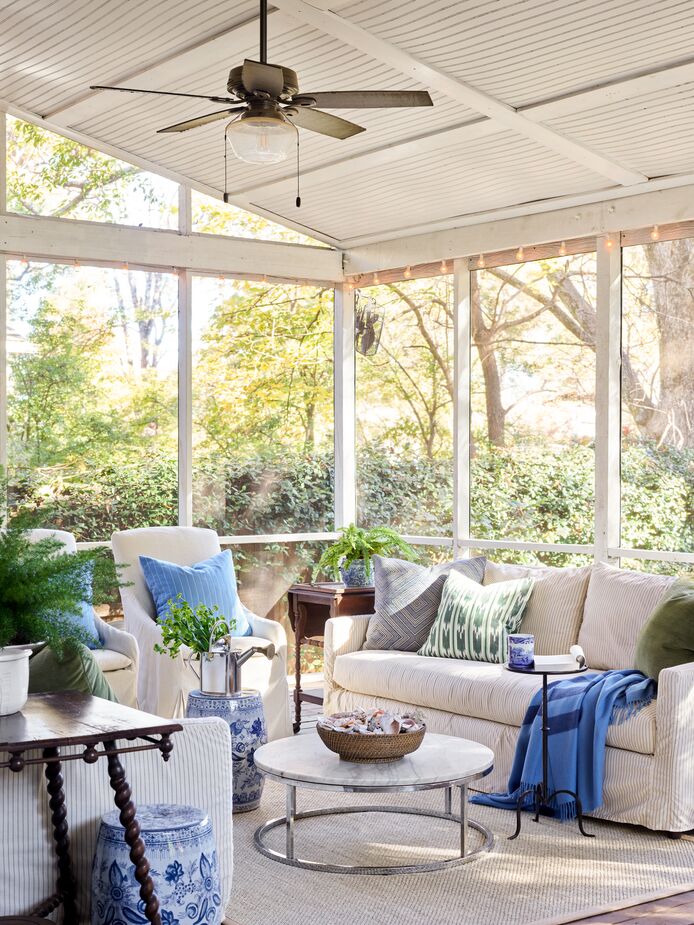 Lathem’s “farm-raised” husband built the back porch, which encompasses living and dining areas and is one of the family’s favorite spaces. “We use that living space at least as much as our indoor one, and the dining area allows us to host larger groups of friends than we can indoors,” she says. Find similar slipcovered chairs here.
