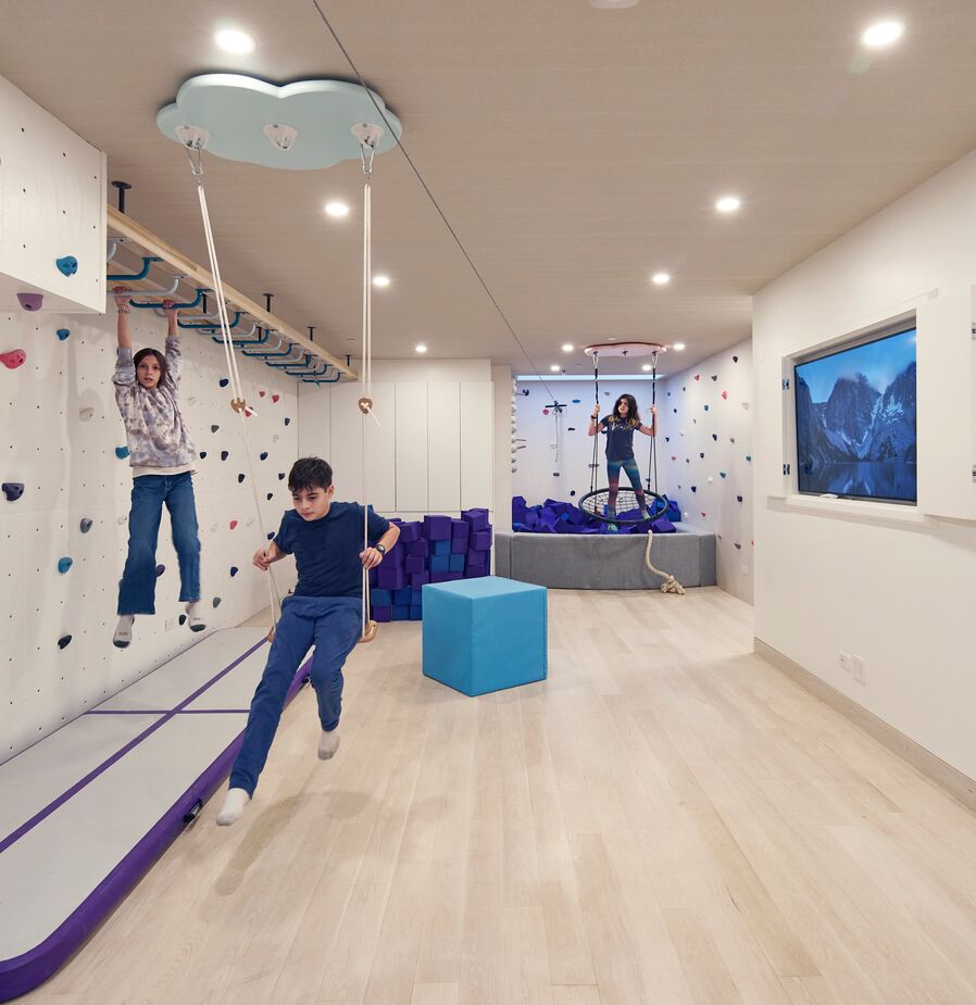 With a zip line, a climbing wall, and a foam pit, the basement is a favorite hangout spot for the daughters and their friends. “I was really envious of how accommodating their mother was!” Jennifer says.
