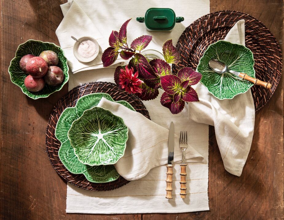 The brown chargers allow the Cabbage tableware to segue gracefully from spring and summer to autumn and winter. Also shown: the Bamboo Place Setting flatware.
