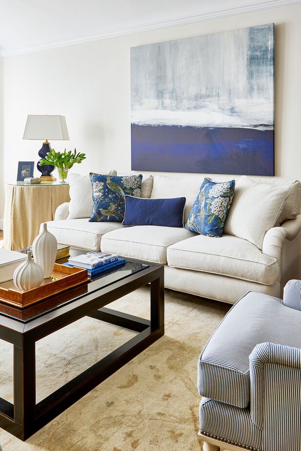 The abstract painting above the Brooke Three-Seat Sofa adds “new” to the “traditional” furnishings; because its colors are echoed throughout the room, the artwork complements its surroundings perfectly. Find the chair here and the coffee table here. Design by One Kings Lane Interior Design. Photo by Tony Vu.
