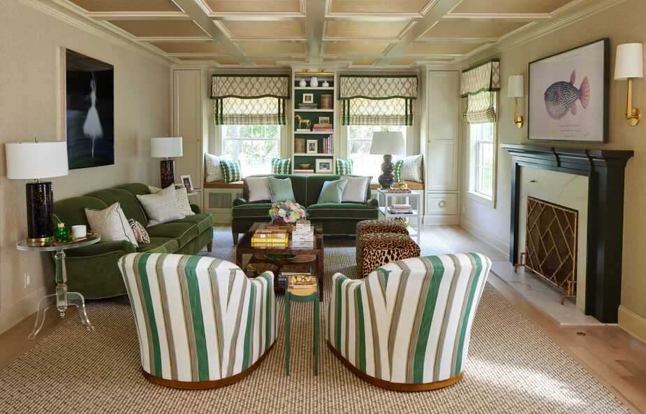 Despite multiple patterns, the living room remains restful thanks to the tight palette, planes of solid color, and thoughtful symmetry. Amanda designed the mantel and added the ceiling coffers.
