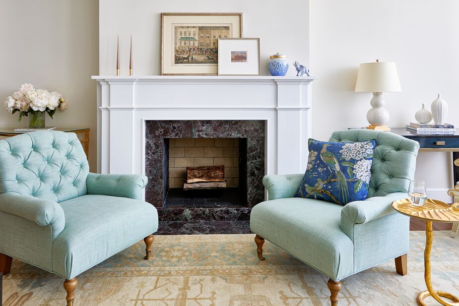 While the Harrison Tufted Accent Chairs in Mint Linen are an identical pair, the rest of the fireplace vignette is balanced rather than matching. Jordan chose a high-quality wool rug for its durability; find a similar one here. Find the decorative pillow here and the side table here. 
