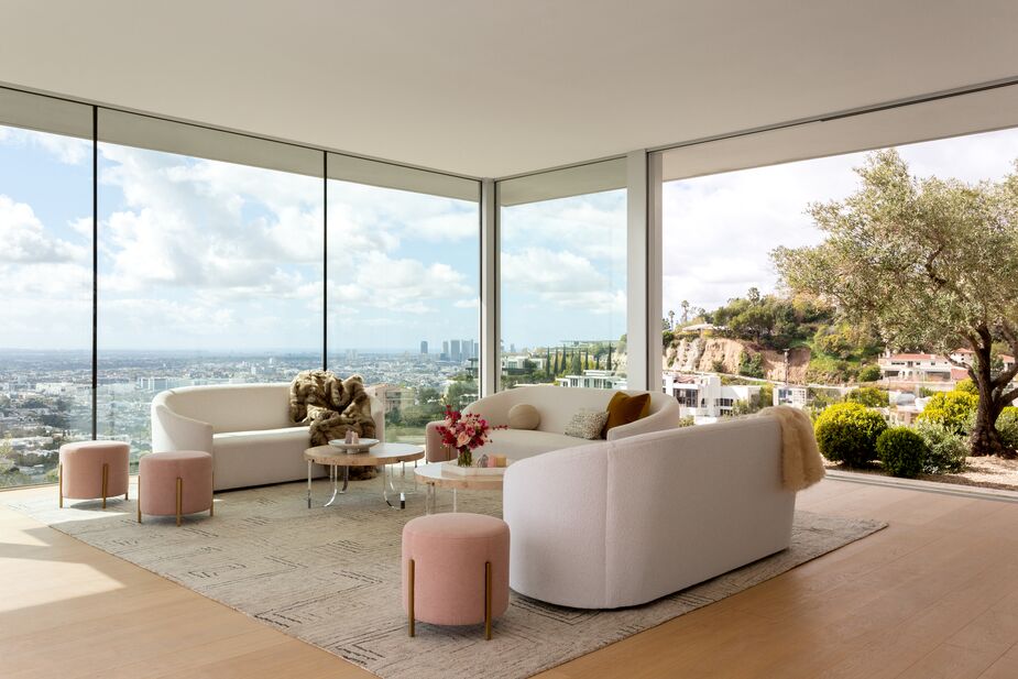 The pink Love Joy Poufs from Miranda’s first furniture collection complement the Serenity Curved-Back Sofas and the Aerial Cocktail Tables from her new assortment. (And how stunning is that view?) Photo by Amy Bartlam.
