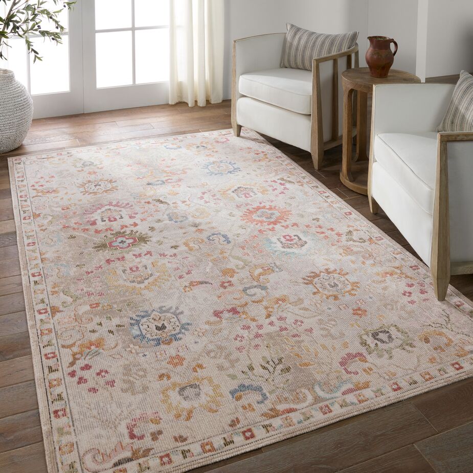 The pale peach ground of the Hesperia Indoor/Outdoor Floral Rug layers a gentle touch of color onto this otherwise neutral space.
