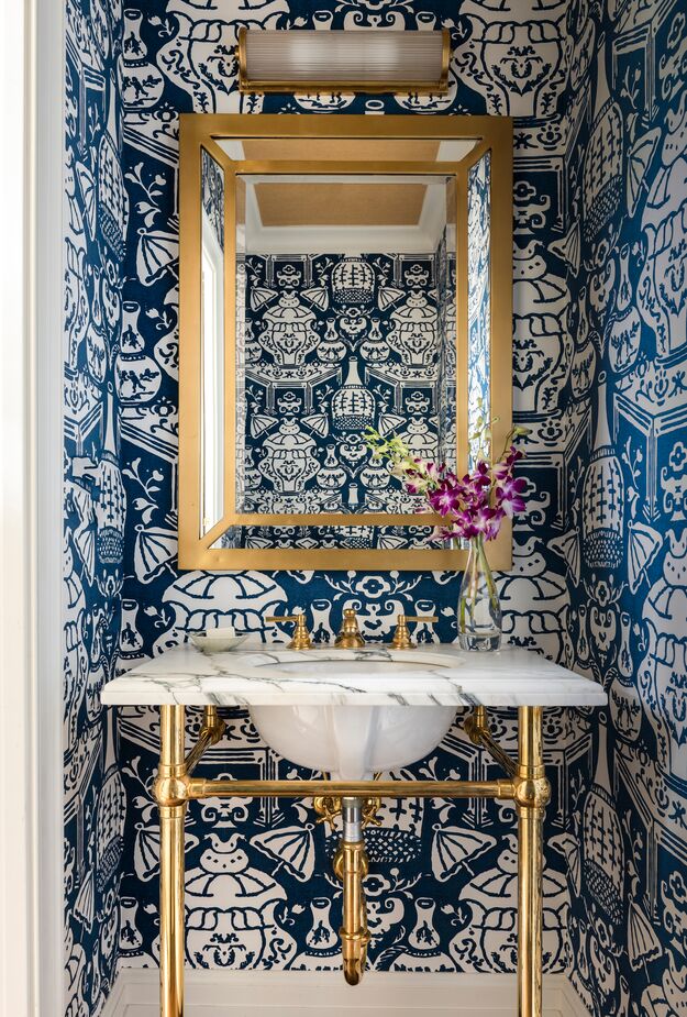 The oversize chinoiserie motif of this powder room’s wallpaper is a playful take on traditional elegance.
