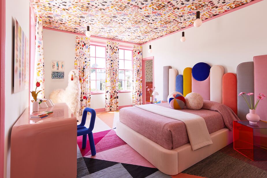 Eugenia and Emma Jesberg, of EJ Interior Design, went all out with the vibrant colors and curves of the 1980s Memphis Design movement. The custom bed also references an up-and-coming trend: oversize upholstered headboards. Photo by Mario Serafin Photography.
