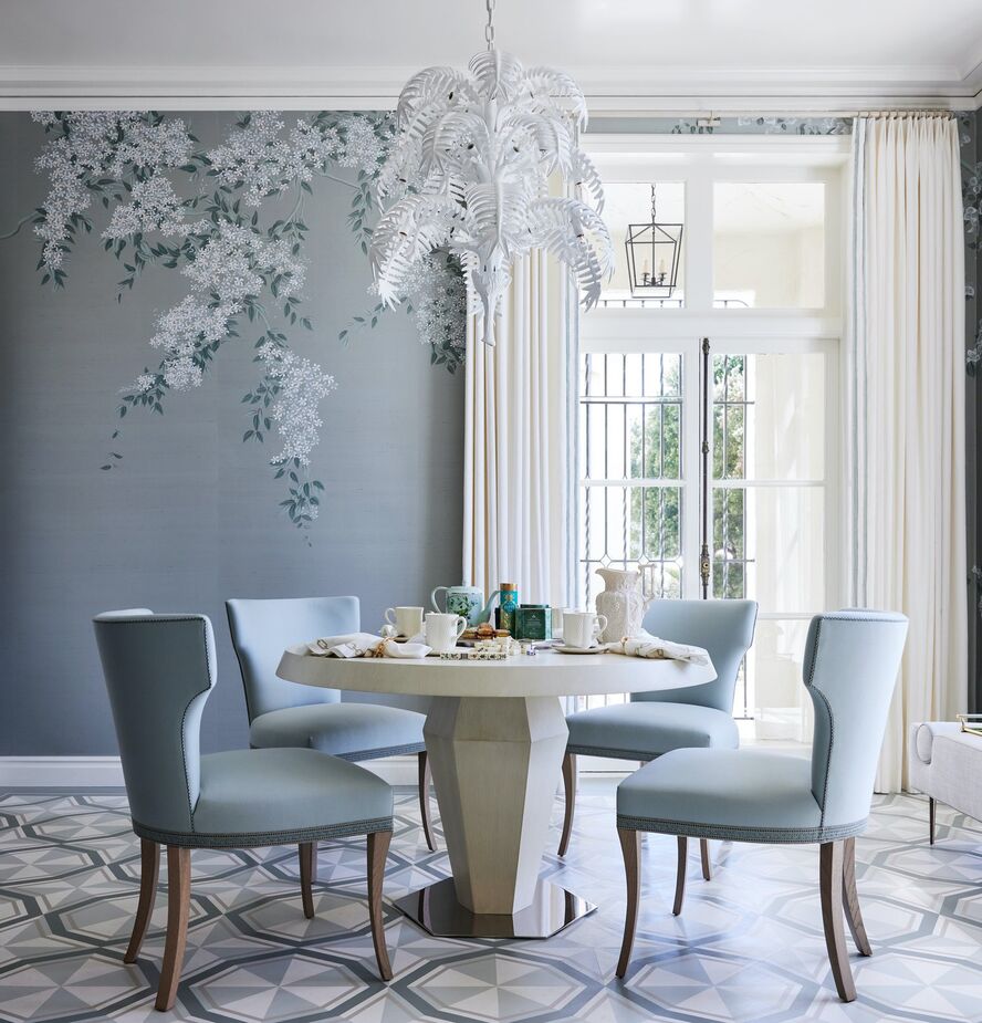 In the home’s “mahjong tea room,” Dina Bandman married the classic (the hand-painted de Gournay floral wallpaper, the klismos chairs) and the contemporary (the hand-painted geometric motif of the floors, the white-oak table). The result is a space conducive not only to playing mahjong and sipping tea but also to dining, reading, and so much more. Photo by John Merkl.
