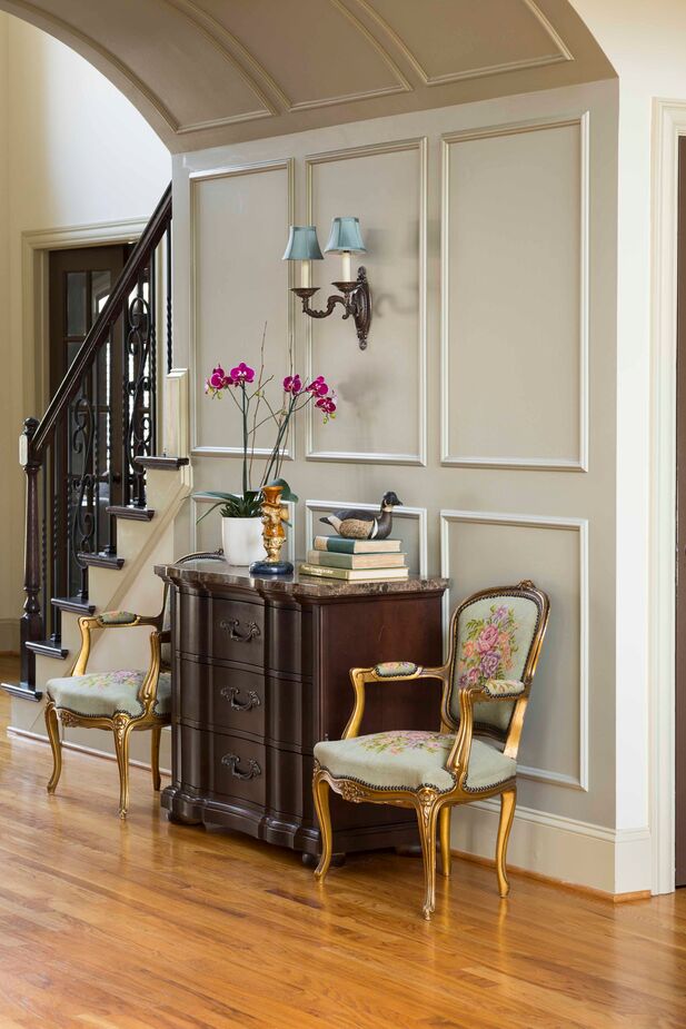 Armchairs with cabriole legs and manchettes make the entry a classic yet convivial area, setting the stage for the rest of the home.
