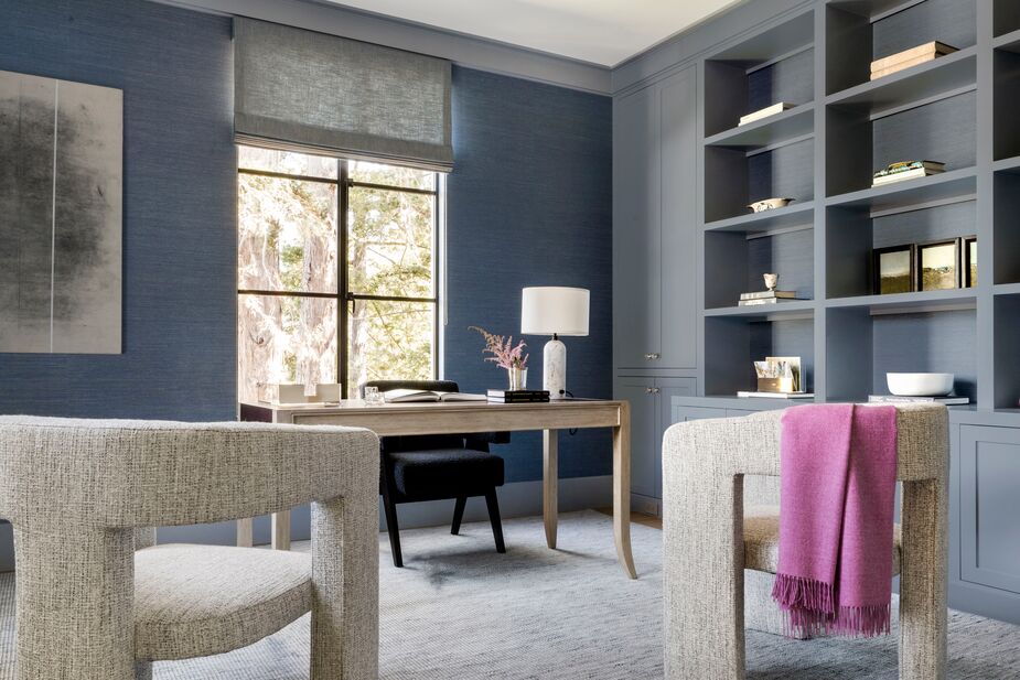 In addition to lavishly textured materials such as bouclé, velvet, and cashmere, Heather used curvy silhouettes to warm up the rooms. In the wife’s office, the guest chairs provide the most obvious curves, but the desk lamp and even the desk’s legs carry through with the theme.
