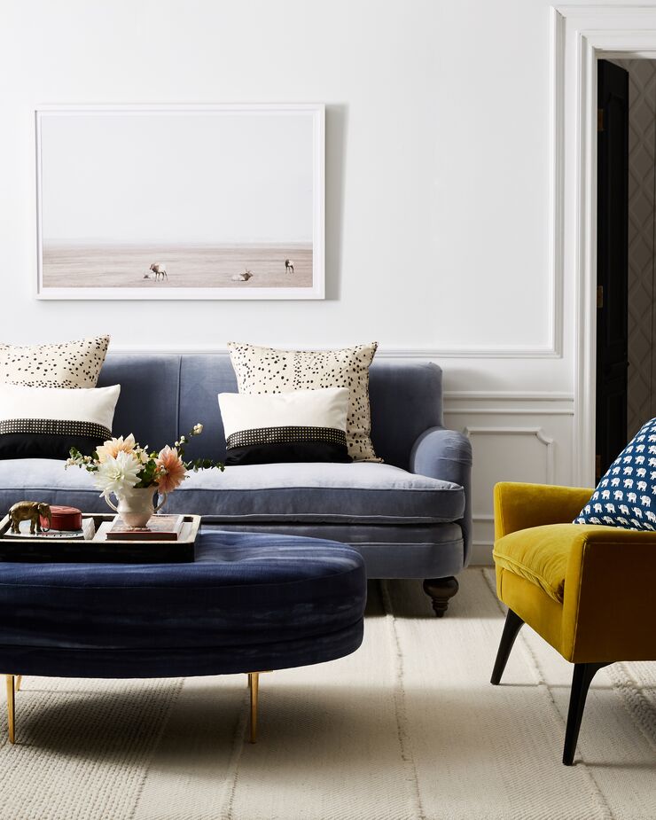 Velvet upholstery in three colors—Delft blue on the sofa, navy on the ottoman, citron on the armchair—brings an element of surprise to this otherwise quiet room.

