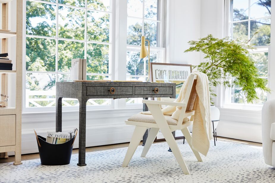 On rainy days, even these large windows won’t provide enough light. Fortunately the Penelope Task Lamp in Brass has an adjustable shade to direct light exactly where you need it. The Kos Raffia 2-Drawer Desk in Charcoal has a wood top to provide a smooth surface for writing and typing. Find the chair here.
