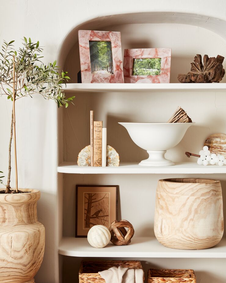 If your first instinct upon seeing an airy alcove like this one is to use it as a dumping ground for keys and spare change, think again—unless you’ve dedicated one of those bowls as where you will place keys and spare change every time you return home. Find the wood bowl/vase here.
