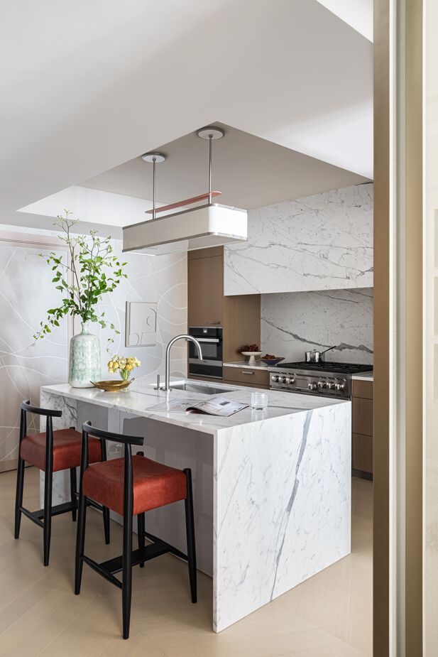 Mirrored sliding doors can close off the kitchen from the living/dining area.
