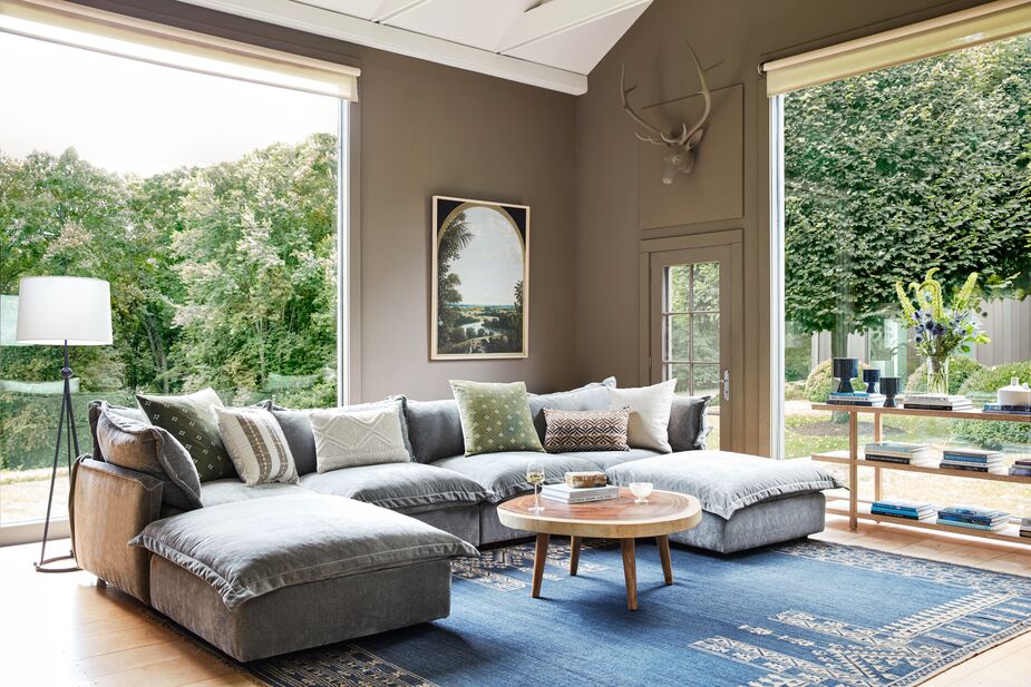 Have a huge family or are constantly entertaining a crowd? Try a U-shape sectional, like the Parker Performance Velvet U-Sectional, which offers the most room for seating. Find the rug here and the coffee table here. Photo by Joe Schmelzer.
