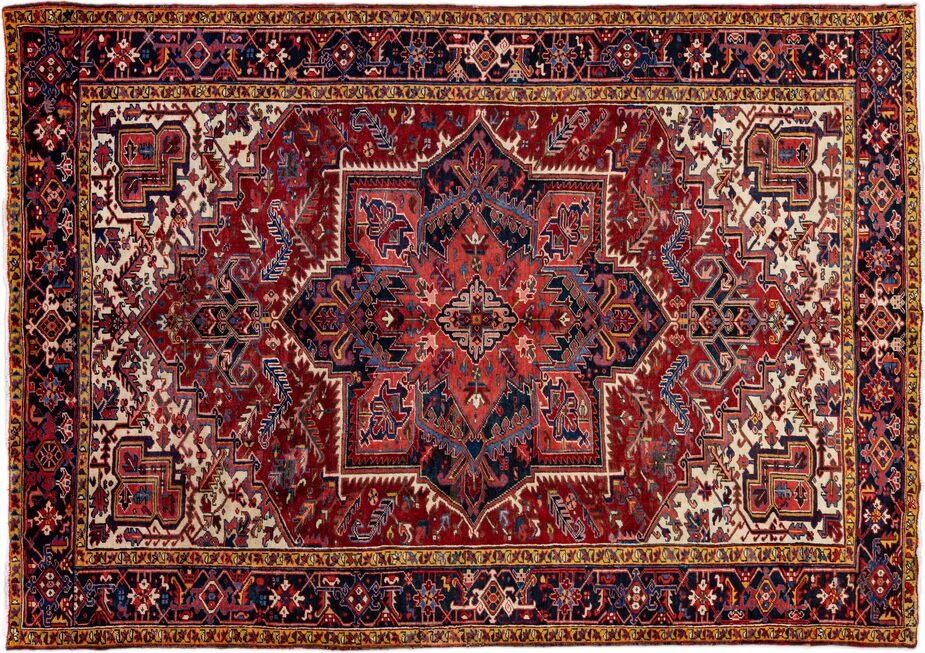 With its rich reds and blues and profusion of geometric motifs, this vintage Heriz is a prime example of the style.
