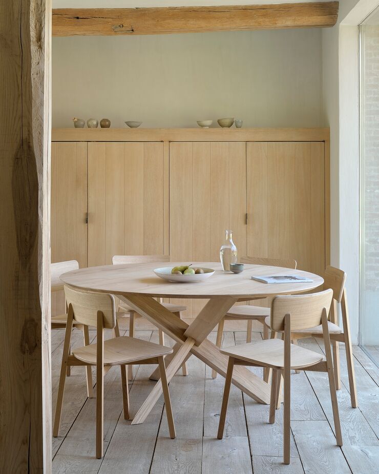 For a Naturalist or Japandi ambience, opt for the palest of browns, such as the Circle Dining Table and the Casae Side Chairs. Unglazed pottery and rattan accessories will underscore the serene, grounded feel. Conversely, a vase in a jewel tone or a black lamp will provide instant drama.
