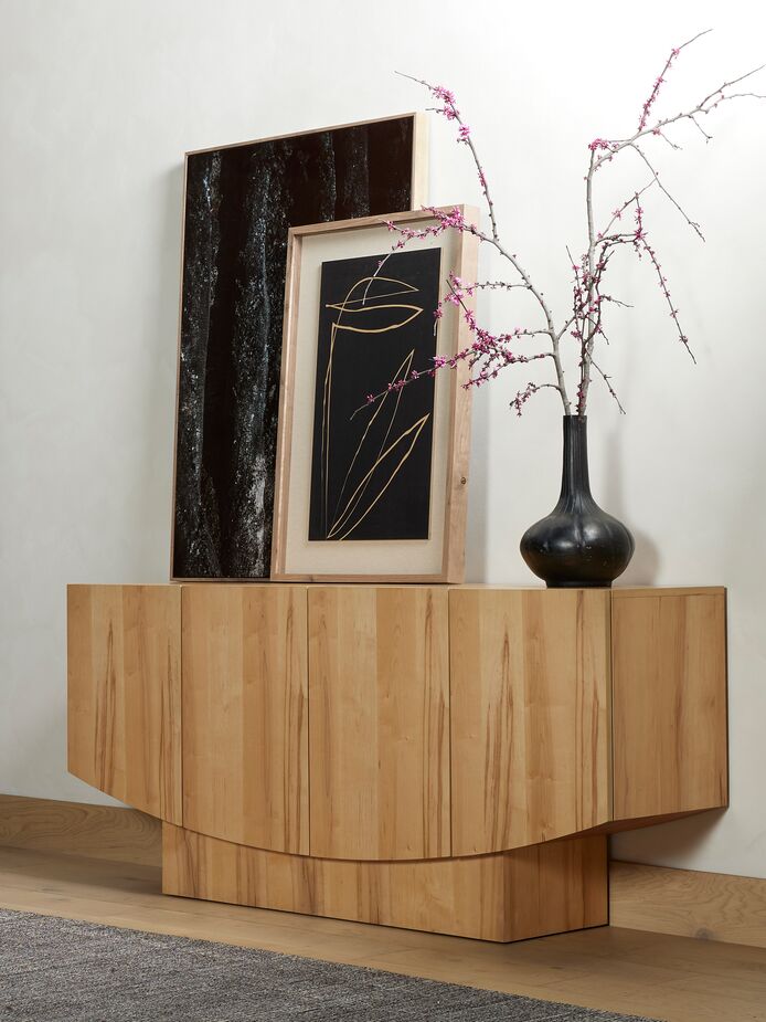The Vienna Sideboard manages to be both substantial and graceful, and its flat, unembellished surfaces show off the beauty of the maple. The shapely vase echoes into the sideboard’s unexpected curves.
