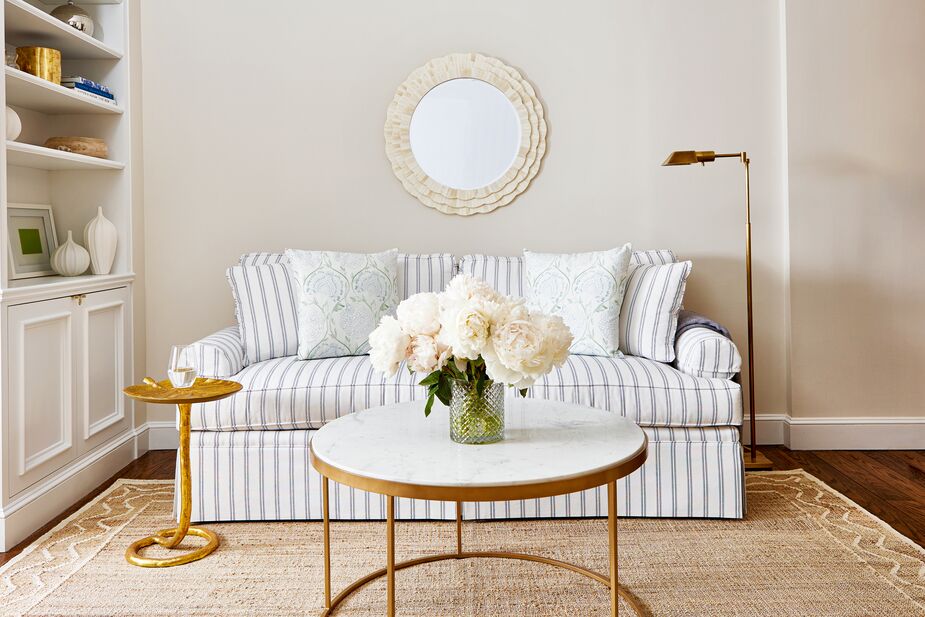 The border of wavy and straight lines distinguishes the Orchard Ripple Rug from other natural-fiber floor coverings. Find the sleeper sofa here, the coffee table here, and the side table here. Room by One Kings Lane Interior Design; photo by Tony Vu.
