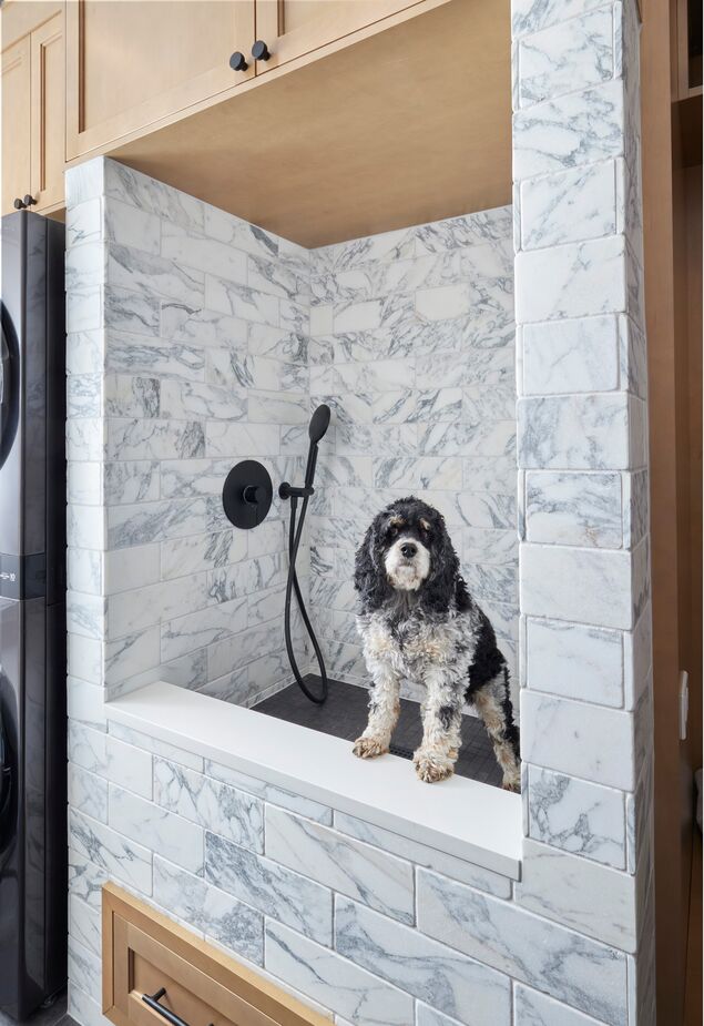 There’s a place for everyone in the family—even the dog gets its own shower in the functional and fashionable basement laundry.
