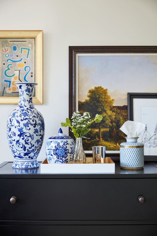 Leaning art against the wall brings a relaxed vibe to this otherwise-traditional tableau atop the Philipe Eight-Drawer Dresser. Find the vase here, the tray here, and the tissue box here.
