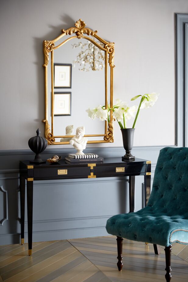 The desk isn’t Regency in style, but the golden accents are in keeping with the era’s emphasis on luxury—and of course, they echo the mirror’s opulent golden frame. The velvet-upholstered Dagny Slipper Chair is equally sumptuous.
