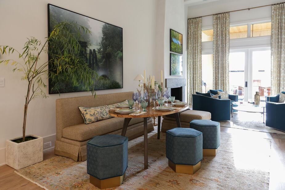 A rug from Keivan Woven Arts reinforces the serene, sophisticated palette of this living and dining area by Hope Austin Interiors. Muted except for punches of blue, the palette provides common ground for the furnishings, which range from traditional to contemporary. Find similar living room chairs here. 
