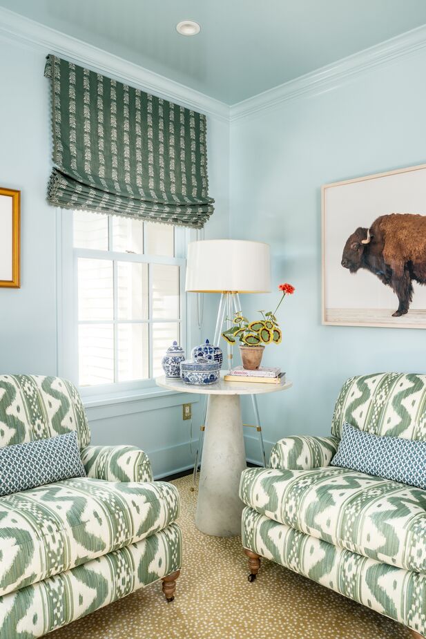 In true Colonial saltbox fashion, the sitting room is just off the center hall entry, opposite the dining room. This corner is a sampling of the pattern juxtapositions that enliven the home. Find a similar rug here. 
