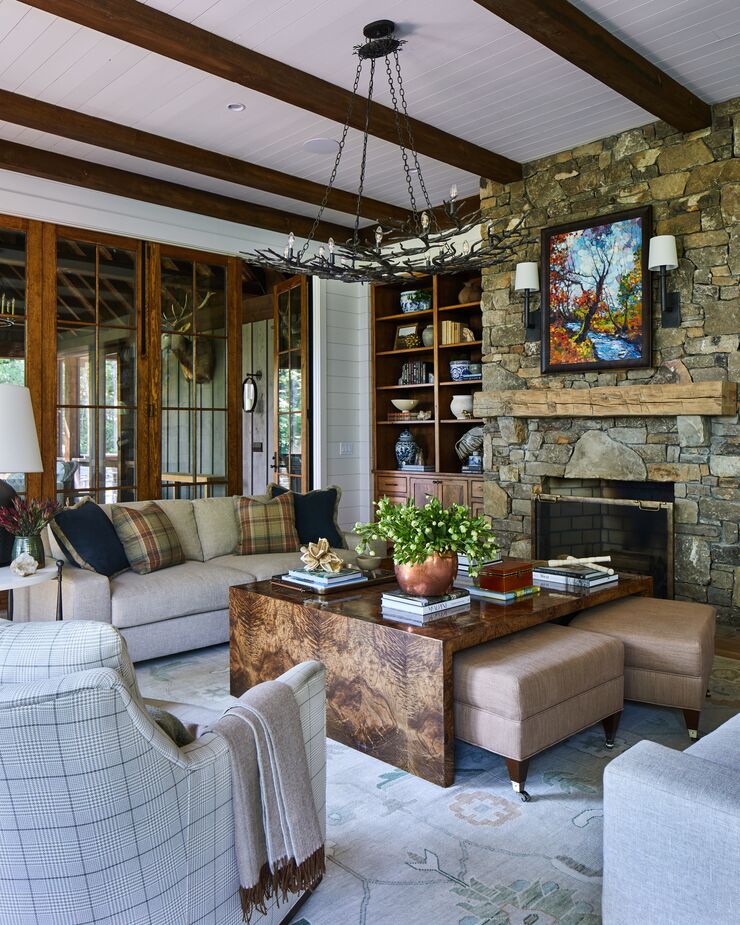 An oversized custom burlwood coffee table takes center stage in the living room, with accenting sofas and a dose of plaid.
