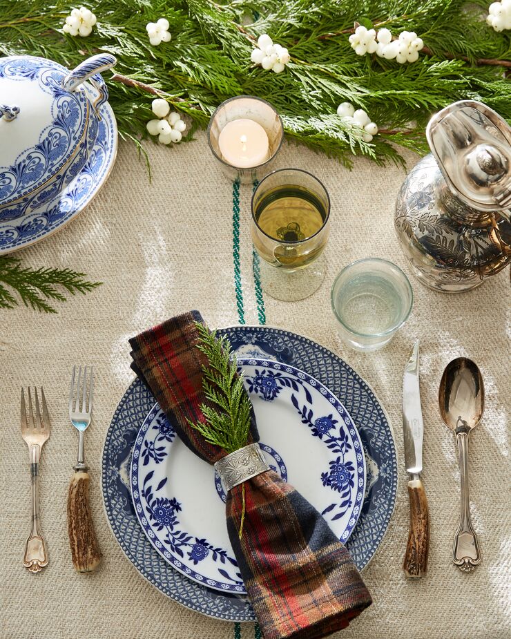 Mixing up vintage dishware of different but similar patterns in the same palette keeps a table from looking old-fashioned. So does complementing formal table settings with plaid napkins or a grain-sack tablecloth. Find a similar tureen and ladle here.  
