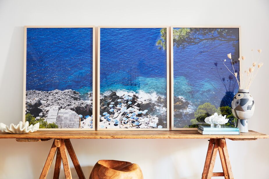 Art that captures blue in nature, such as this triptych by Natalie Obradovich, effortlessly adds the color to an otherwise neutral room. Find the vase here. Photo by Joe Schmelzer
