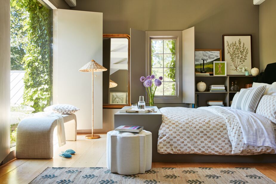 Just a few deep greens—the trees adorning the Orchard Verdure Rug, the stripes on the Luli Pillow, the artwork leaning against the wall—update this bedroom. Artwork from left: Hills of the Champagne Region V; Leopard I; and Vintage Botanical Plate. The Celia Waterfall Linen Bench in Talc and the Terrace Rattan Floor Lamp contribute plenty of organic texture. Find the ottoman here and the duvet cover here.

