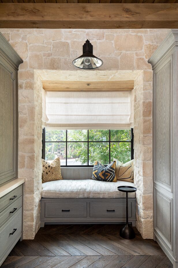 The window seat serves as a cozy hideaway, with the built-in drawers beneath providing always-welcome storage. Find a similar side table here.
