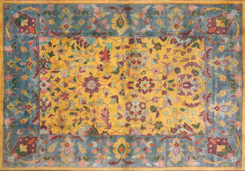 The colors in this antique Agra rug range from deep burgundy to soft pink.
