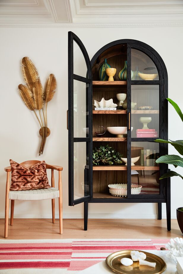Sconces are fashionable as well as functional. The Tropical Sconce here serves as a wall sculpture in addition to transforming this space into a reading nook. Photo by Joe Schmelzer.
