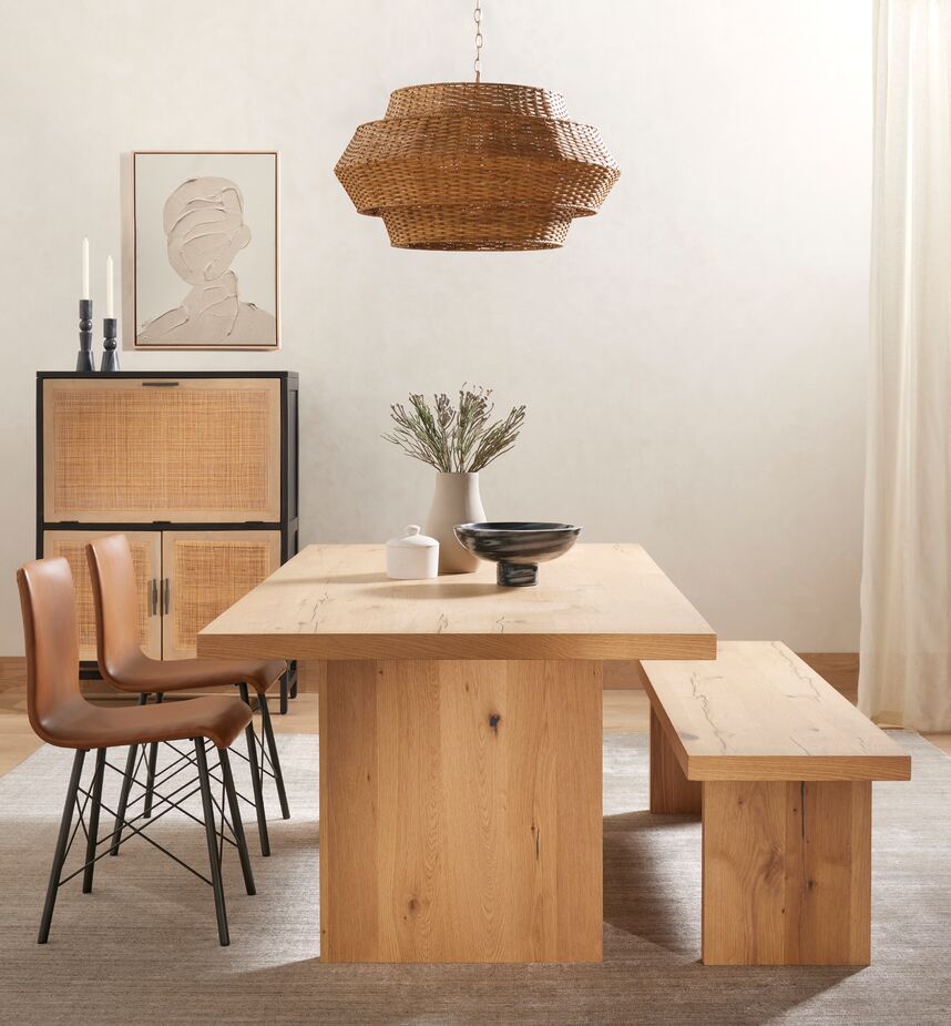 Modern shapes give farmhouse-favorite materials a fresh energy. Case in point: the geometric silhouette of the Oliver Rattan Pendant. Find the bar cabinet, made of black-washed wood and cane, here. 
